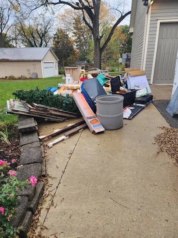 Dumpster being loaded with debris for 12 Yard Dumpster Rental in Munhall
